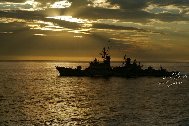 MC10.jpg - Guided missile destroyer HMAS Hobart (now a dive wreck off South Australia) underway off the NSW coast at sunset.
