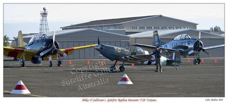AC13.jpg - Two T-28 Trojans dwarfing a Spitfire replica in the early morning light.