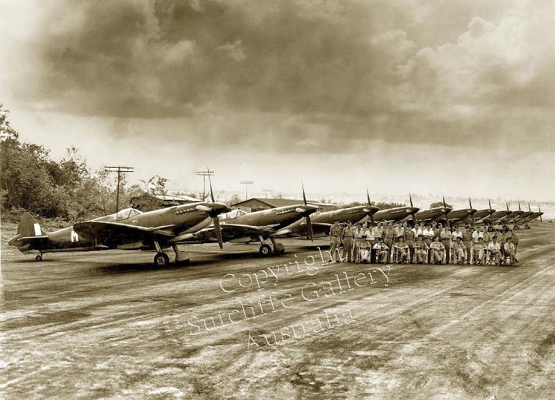 AC20.jpg - The first appearance of Spitfires in Australia. Darwin, 1944 with the squadron of Mk.VIIIs lined up and the crews in front. Splendid. Not available in colour.