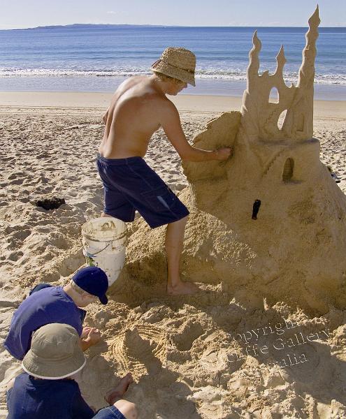 PC05.jpg - Sand castles have always held a place of fascination for many of us when we go to the beach, but this one is a winner. Even the young fellow at left is inspired to follow suit.
