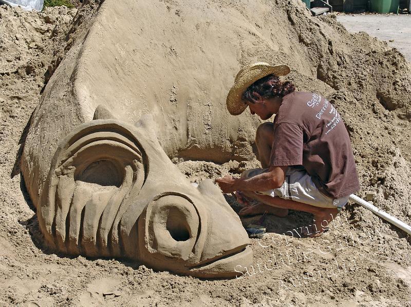 PC14.jpg - Dennis Massoud, a top class professional sand castle builder is seen here well undeway into producing a sleeping dragon